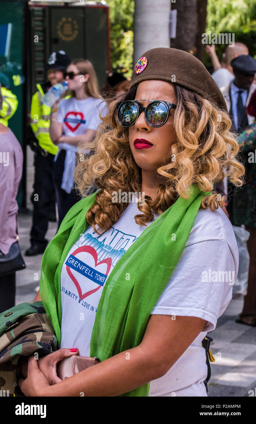 Portrait of woman at the base of Grenfell Tower, where family members and friends of the victims congregate to mark the one year anniversary of the fire, London, England, UK, 14th June 2018 Stock Photo