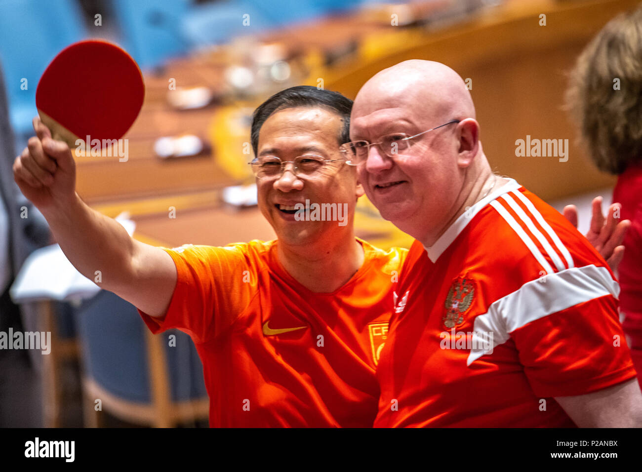 New York, USA, 14 June 2018. Vassily Nebenzia, Permanent Representative of the Russian Federation to the United Nations and President of the Security Council for the month of June R) poses with China's Ambassador to the UN Ma Zhaoxu holding up a table tennis racket as they wear soccer jerseys  to mark the opening day of the 2018 FIFA World Cup, being hosted by the Russian Federation from 14 June to 15 July. Credit: Enrique Shore/Alamy Live News Stock Photo
