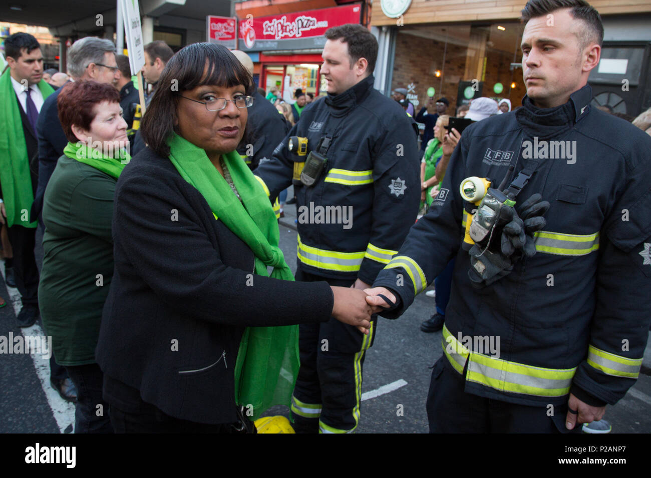 London UK 14th June 2018   Diane Julie Abbott MP greets fir firefighters during a silent march to St Marks Park (Kensington Memorial Park)  on the one year anniversary of the Grenfell Tower fire. Credit: Thabo Jaiyesimi/Alamy Live News Stock Photo