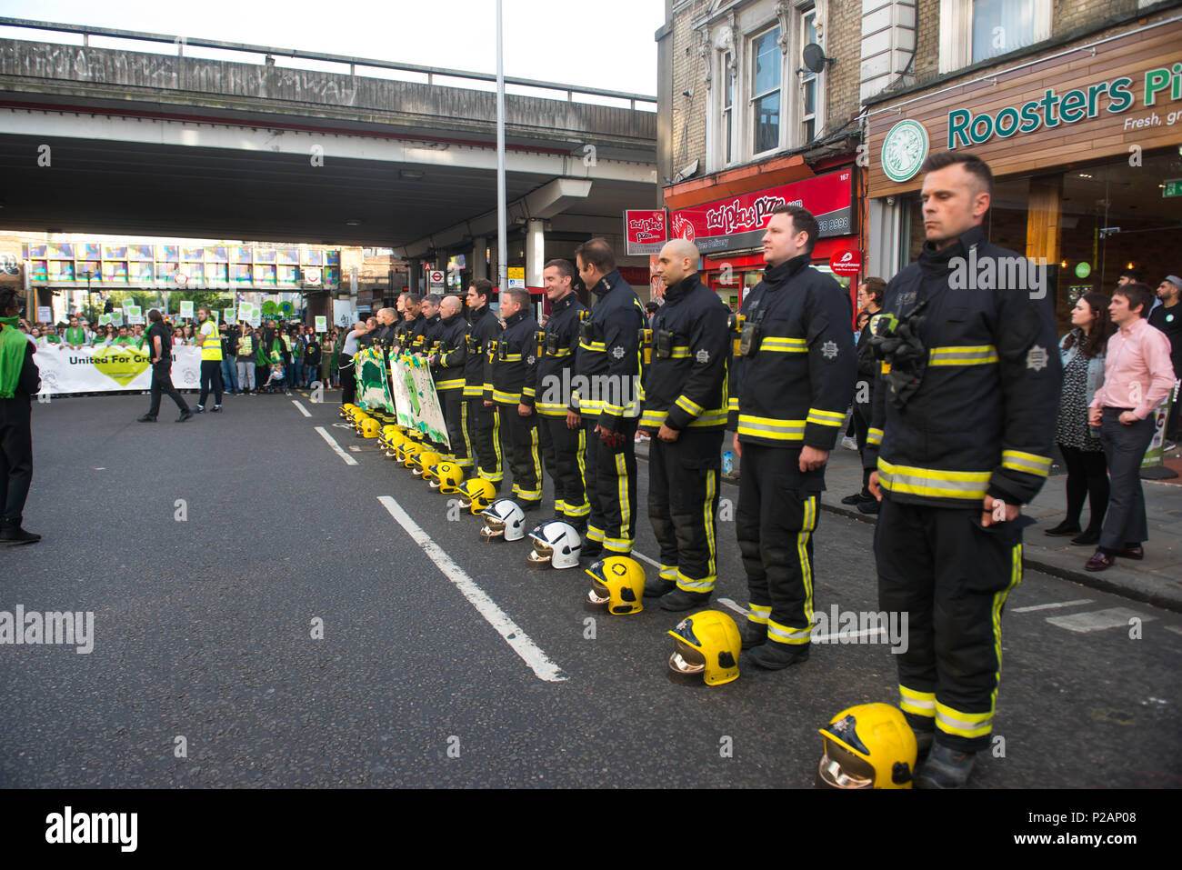 London, England. 14th June 2018. People stop to hug / greet firefighters during a silent march. Grenfell Tower fire Silent walk is held to mark the first anniversary of the Grenfell Tower fire, which claimed the lives of 72 people. ©Michael Tubi/Alamy Live News Stock Photo