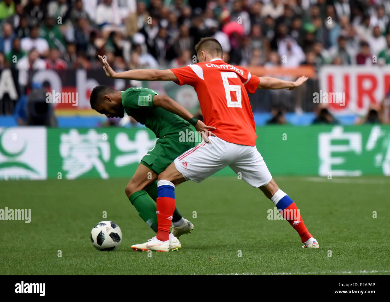 Moscow, Russia - June 14, 2018. Saudi Arabian defender Mohammed Alburayk against Russian midfielder Denis Cheryshev in the opening match of FIFA World Cup 2018 Russia vs Saudi Arabia. Credit: Alizada Studios/Alamy Live News Stock Photo