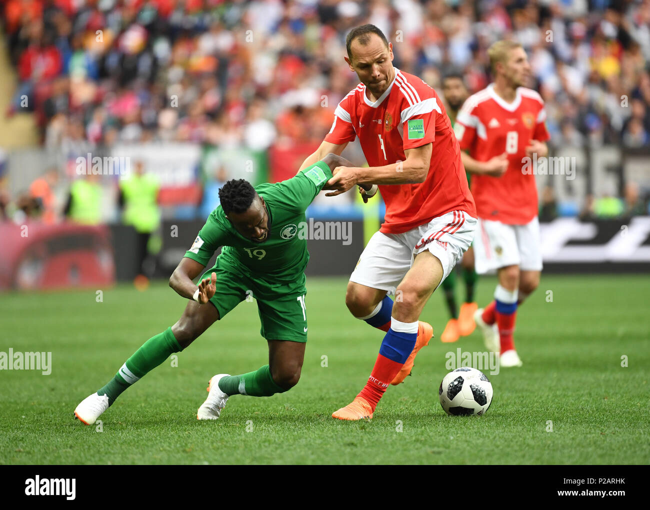 Moscow, Russia. 14th June, 2018. Soccer; FIFA World Cup, First Round, Group A, First Matchday, Russia vs. Saudi Arabia at the Luzhniki Stadium: Sergej Ignaschewitsch from Russia and Fahad Al-Muwallad (L) from Saudi Arabia in action. Photo: Federico Gambarini/dpa Credit: dpa picture alliance/Alamy Live News Stock Photo