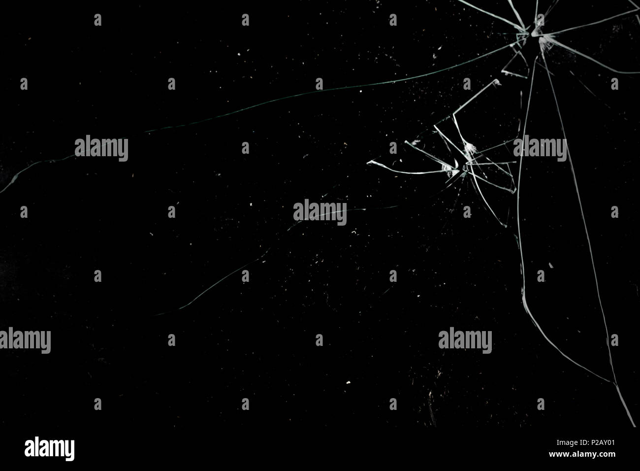 A broken glass on a deep black background. Useful texture for overlay. Stock Photo