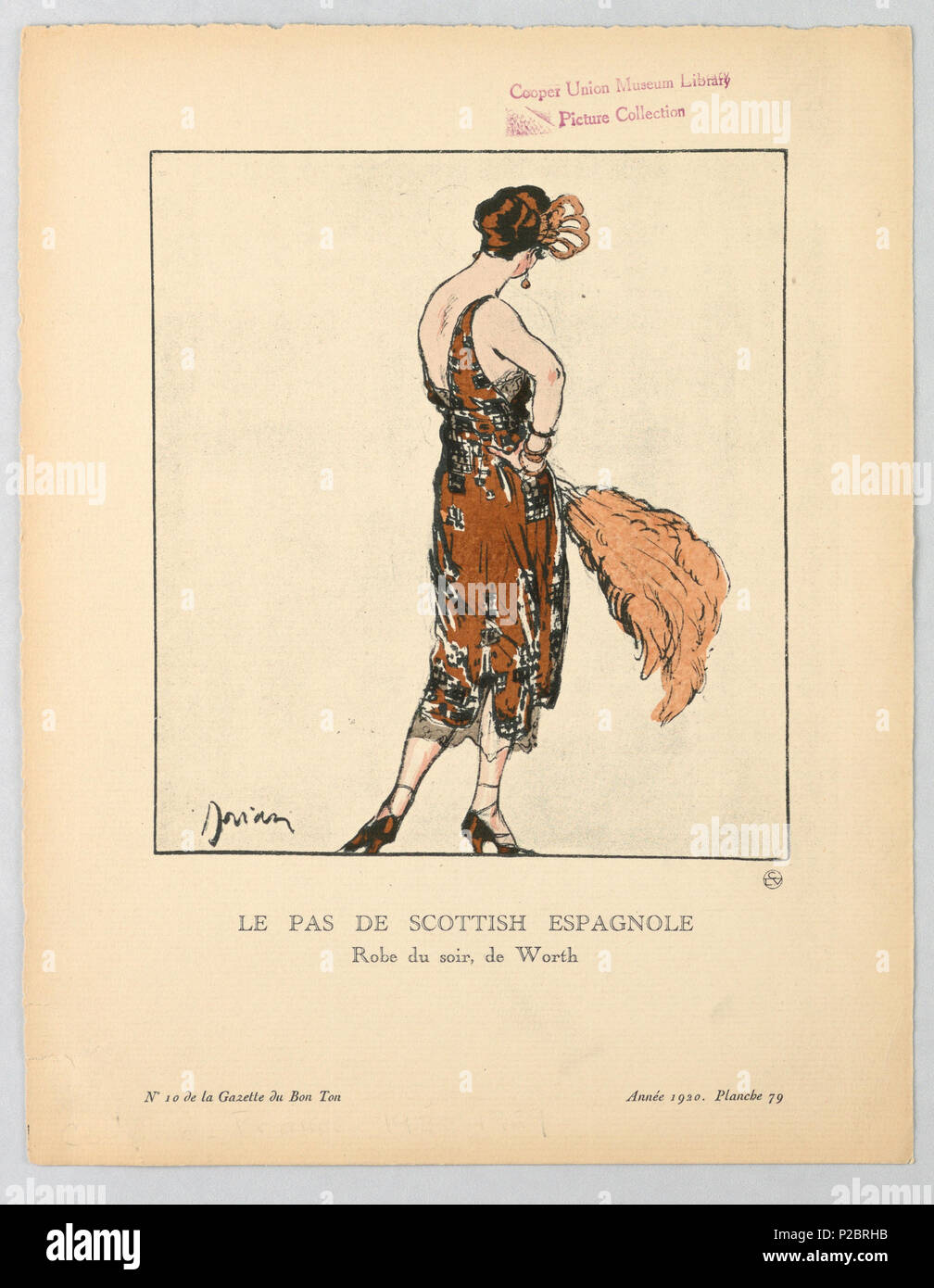 .  English: Print (France), 1920 .  English: The caption reads: Le Pas De Scottish Espagnole / Robe du soir, de Worth. Back facing the viewer, a woman stands wearing a copper colored low-back evening gown with lace detailing and black beading. Her dress reveals her matching heels that lace up the ankle. In her left hand she holds a large plummed fan. . 1920 261 Print (France), 1920 (CH 18614947) Stock Photo