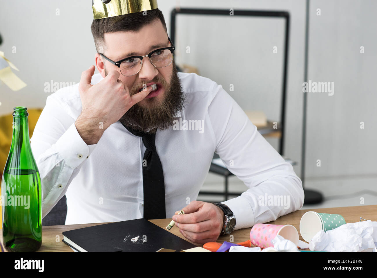 businessman taking drugs at workplace in office Stock Photo