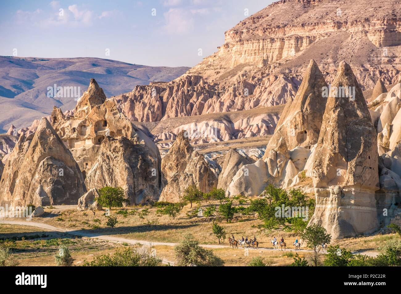 Turkey, Central Anatolia, Nev&#x15f;ehir province, Cappadocia UNESCO World Heritage Site, Kiliçlar, horse riding in the Valley of the Swords, landscape of volcanic tuff hills and vestiges of troglodyte dwellings of the Göreme National Park Stock Photo
