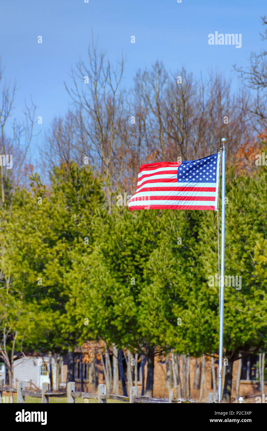 The American flag, star and stripes, fluttering in the wind on a cool April morning, in Northern Michigan. Star Spangled Banner. Red, White and Blue. Stock Photo