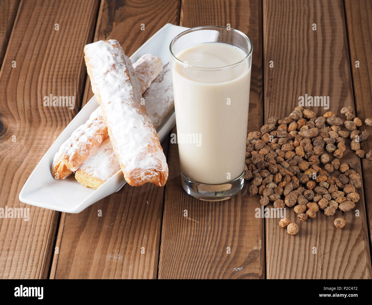 Horchata is a drink, made with the juice of tigernuts and sugar.  Native from Valencia – Spain, it is a refreshing drink, often accompanied with long Stock Photo