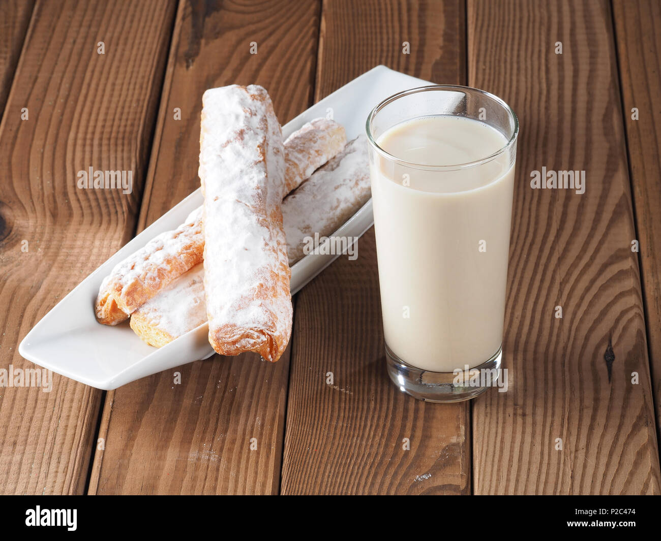 Horchata is a drink, made with the juice of tigernuts and sugar.  Native from Valencia – Spain, it is a refreshing drink, often accompanied with long Stock Photo