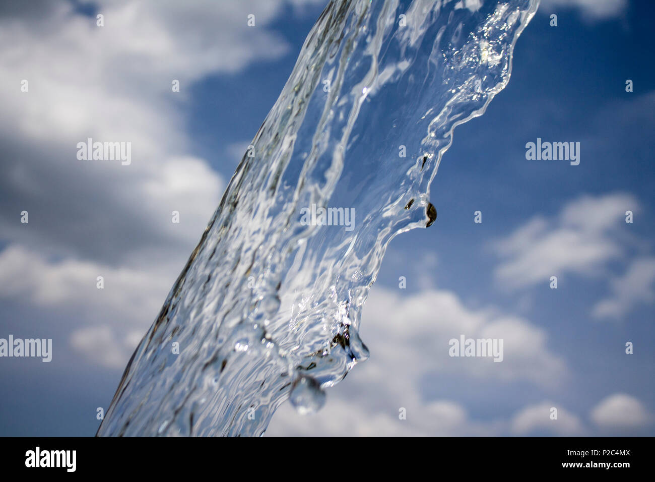 Photo of stream of water over sky background. Close-up view Stock Photo