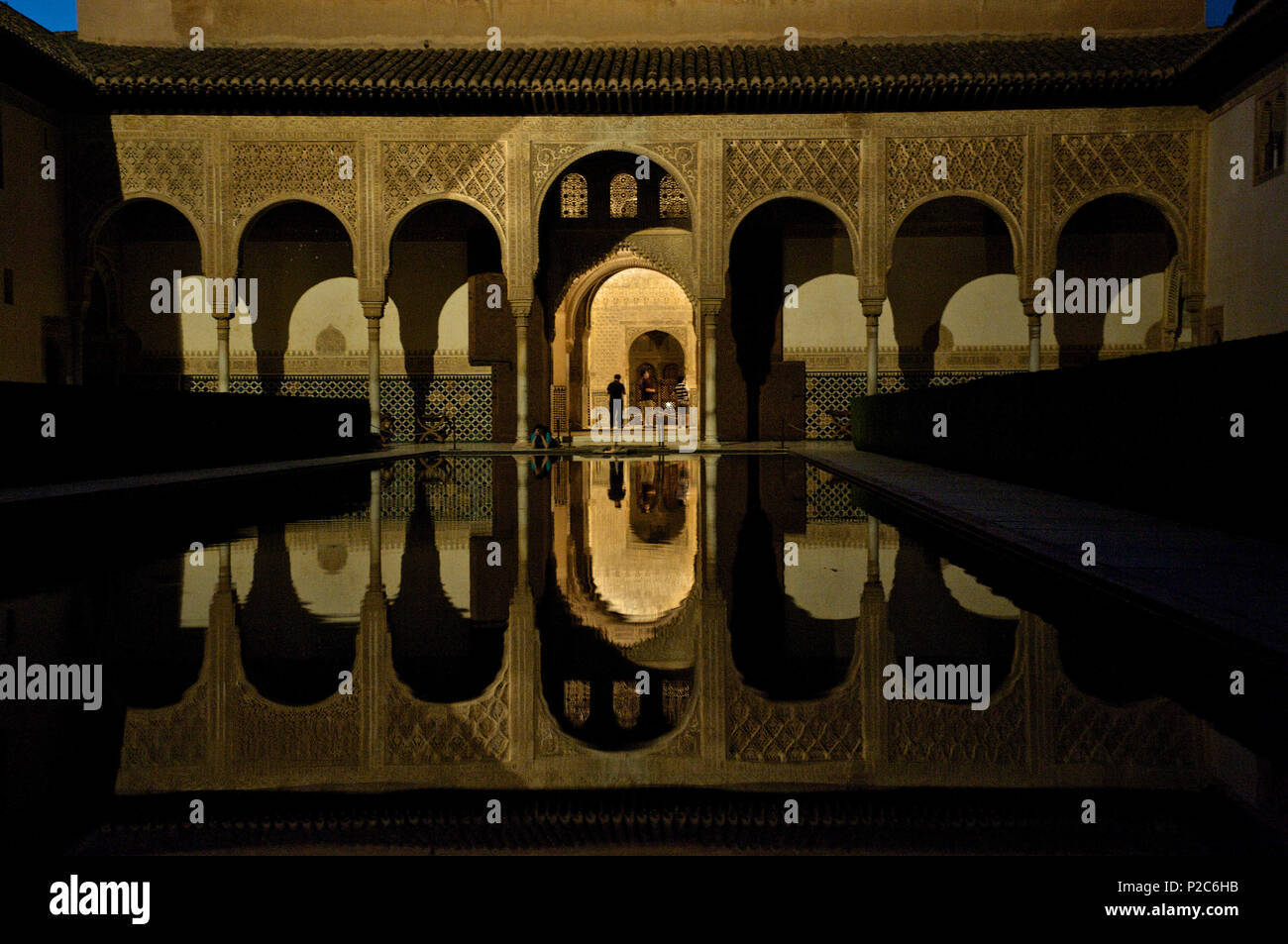 Fine Moorish wall decorations in the Nasrid palace in the Alhambra, reflections in a pool, night visit, Granada, Andalusia, Spai Stock Photo