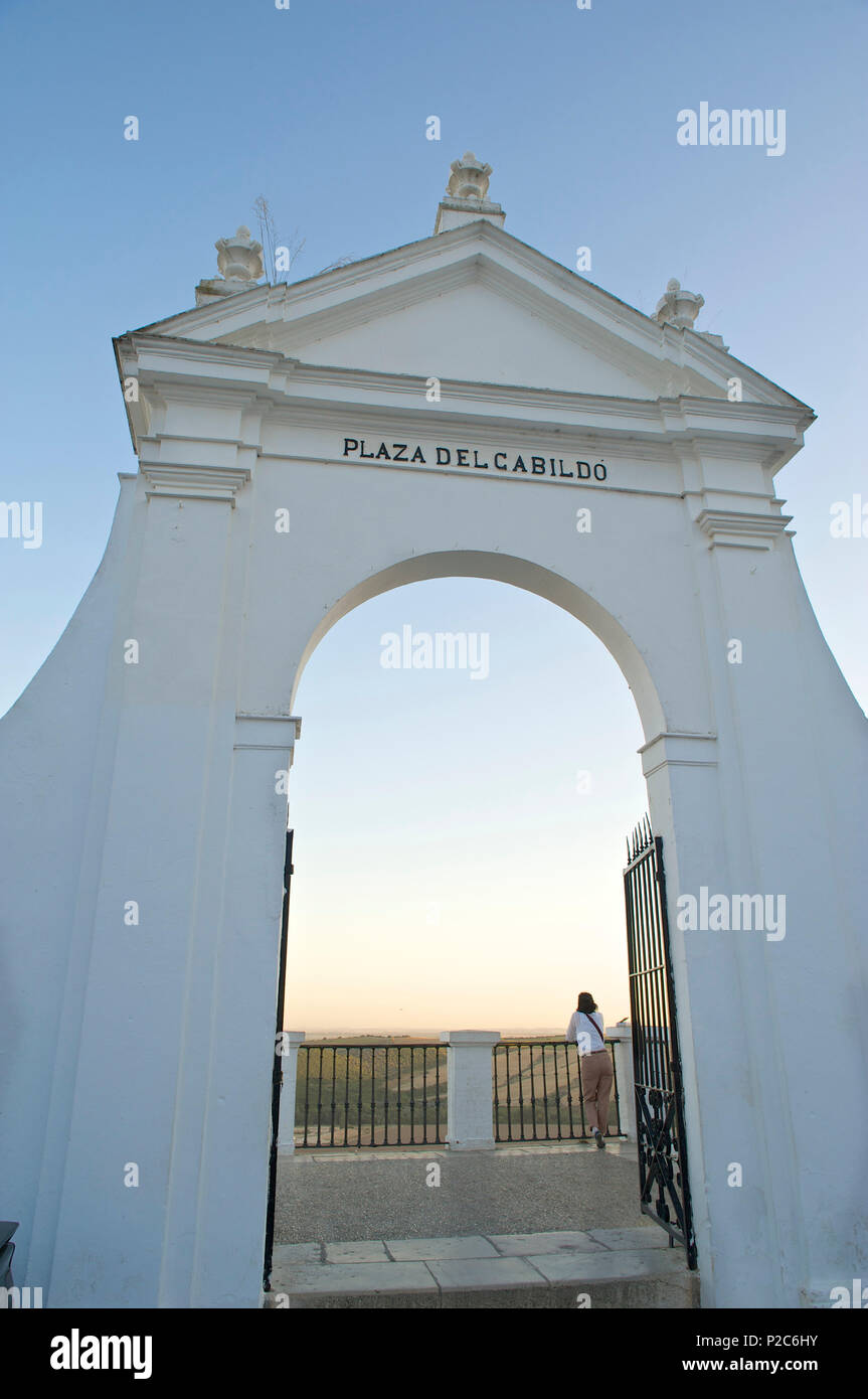 View through the gate at the Plaza de Cabildo, woman looking over the surrounding area, Arcos de la Frontera, Cadiz province, An Stock Photo