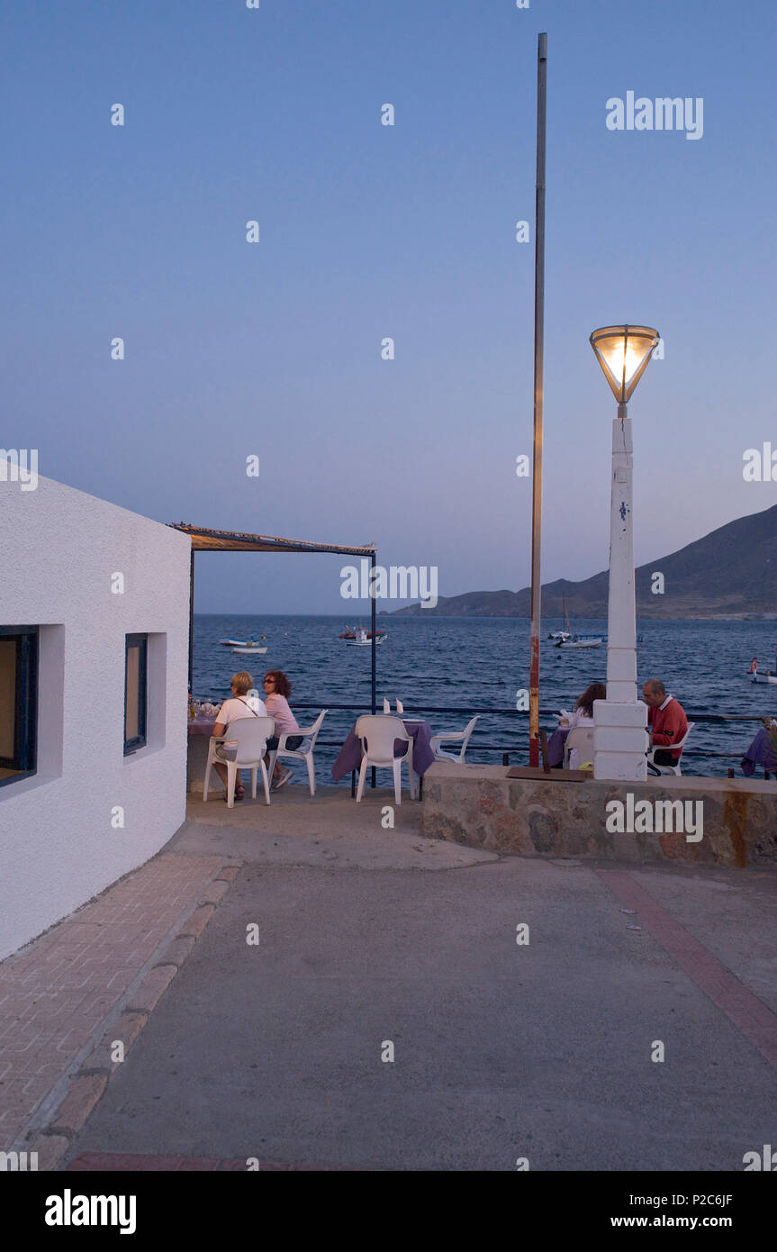 Restaurant at the small harbour in La Isleta in the evening at Cabo de Gata, Almeria province, Andalusia, Spain Stock Photo