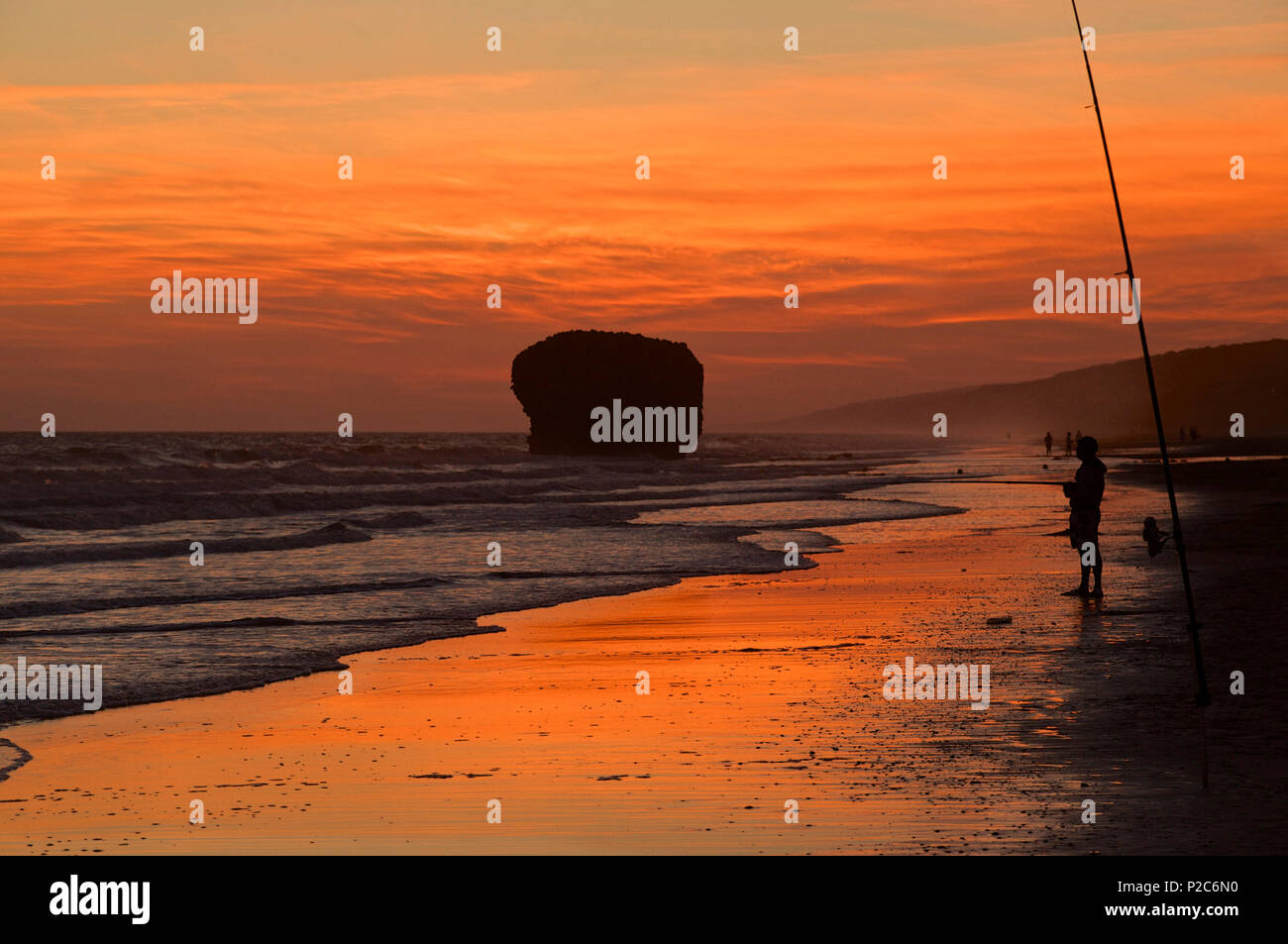 Man fishing at the Playa de Mazagon near Matalascanas in the evening glow, Provinz Huelva, Andalusia, Spain Stock Photo