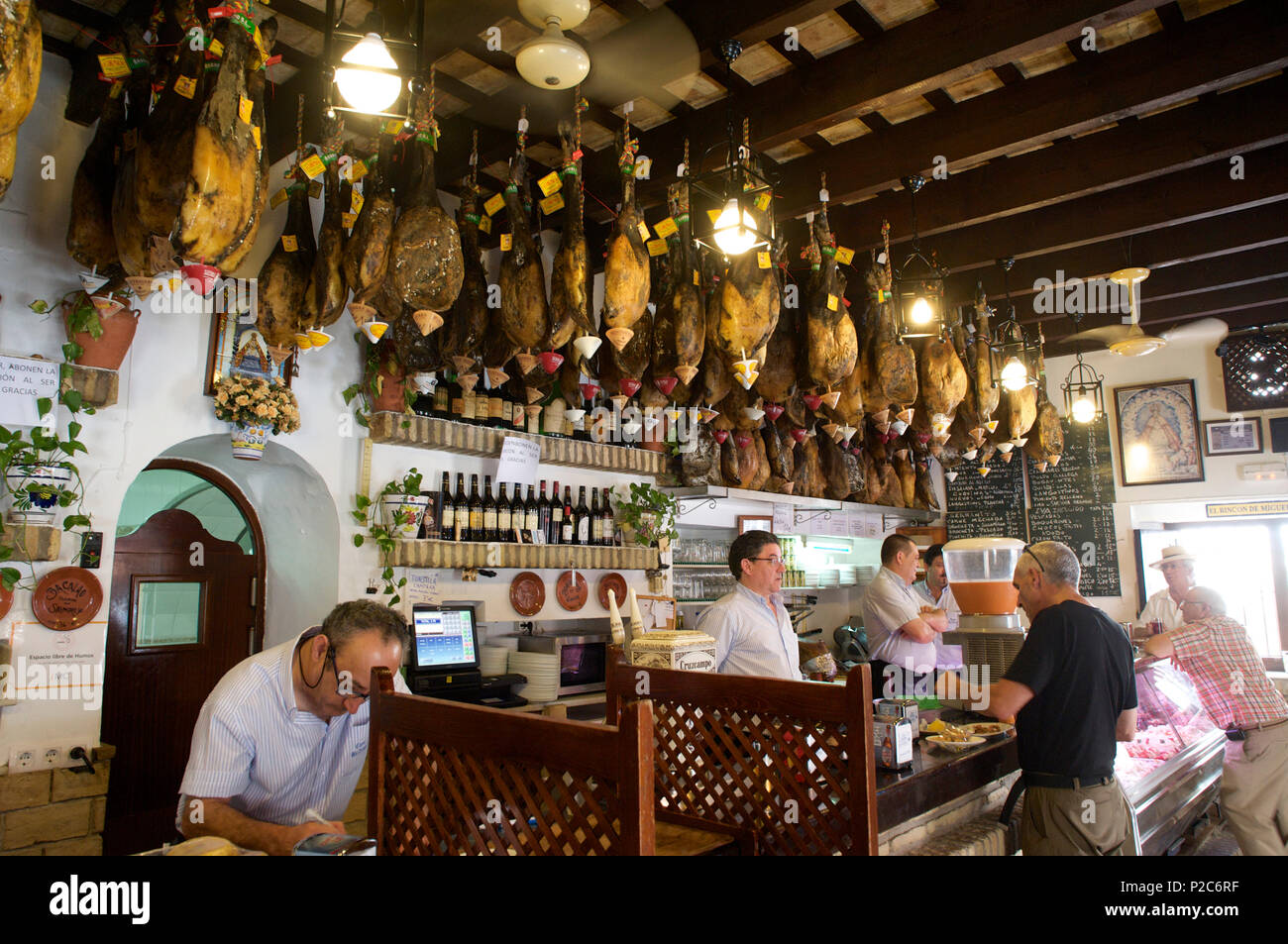 Pata Negras, Spanish ham speciality, hanging from the celing in the Bar Casa Balbino in Sanlucar de Barrameda, Cadiz province, A Stock Photo