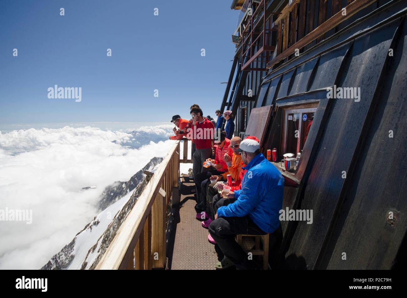 Alpinists in front of the Margherita Hut on the summit of the 4554 meter high Signalkuppe or Punta Gnifetti, highest hut in the Stock Photo