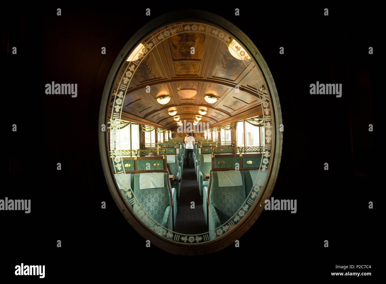 View through a decorated door window into one of the historic wagons of the Golden Pass Railway travelling on the Montreux-Berne Stock Photo
