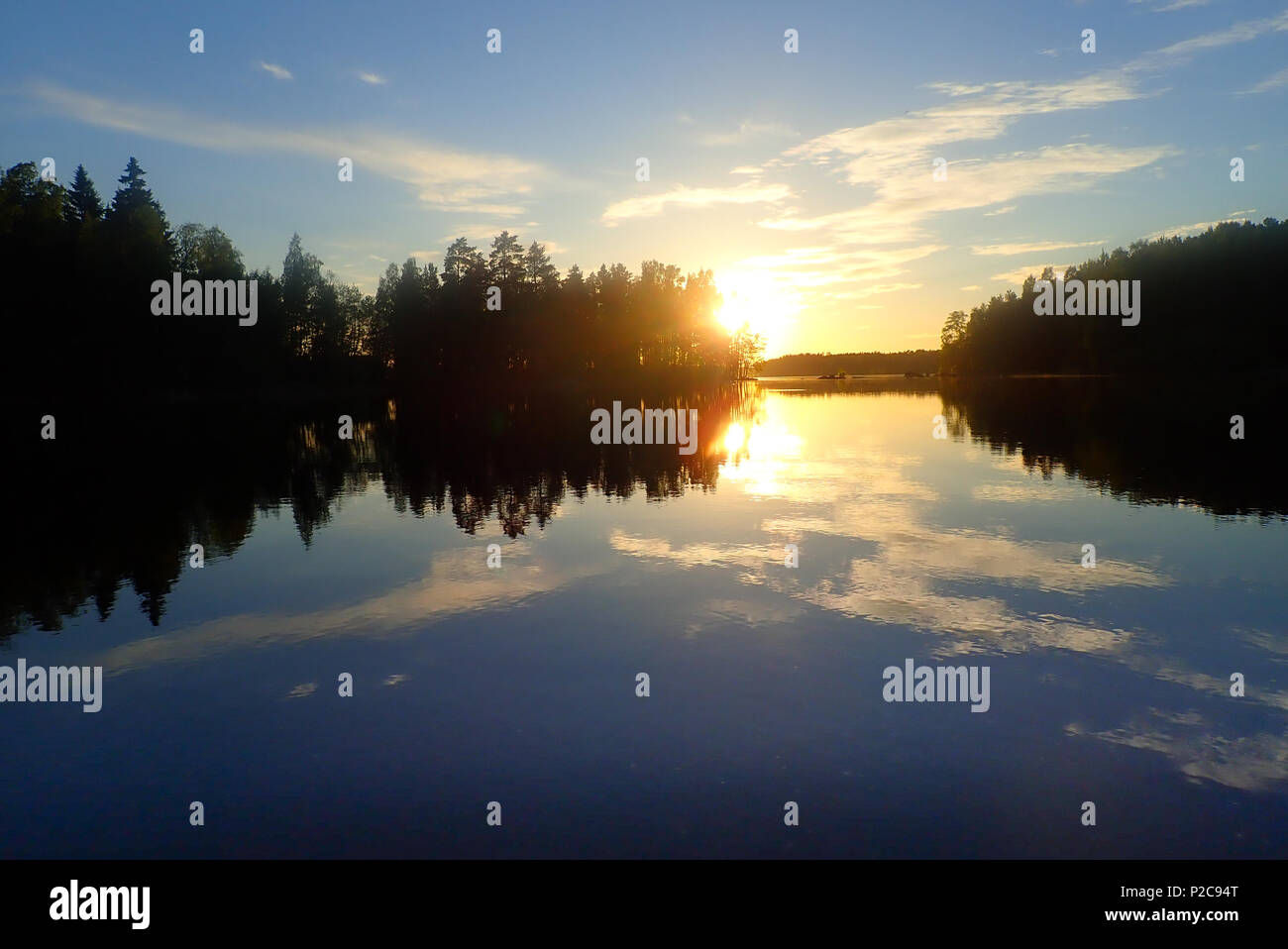Sunset reflections. Lake Kukkia, Luopioinen, Finland. 24.6.2018 Stock Photo