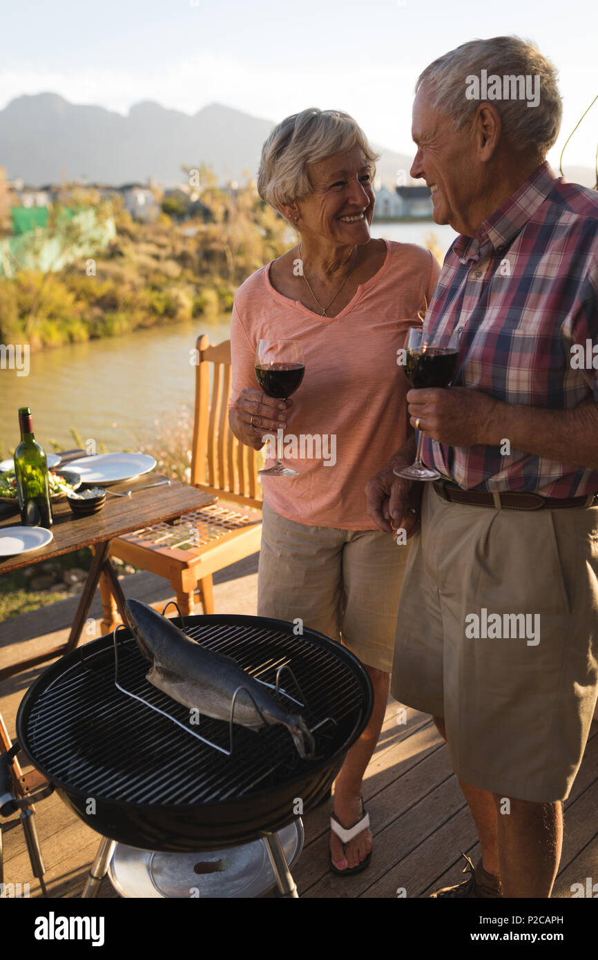 Senior couple having wine in the backyard Stock Photo