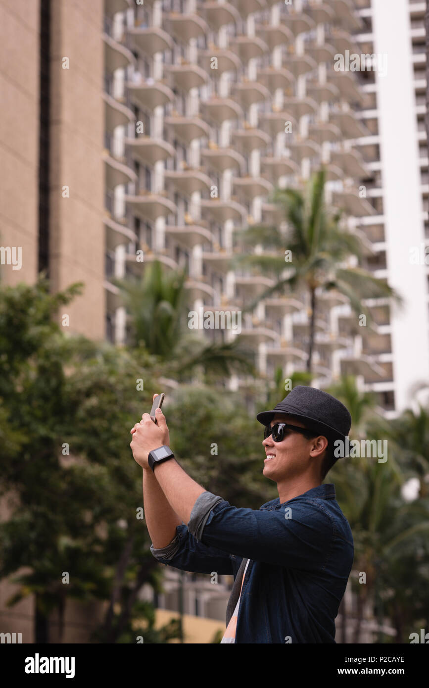 Man clicking photo with mobile phone Stock Photo Alamy