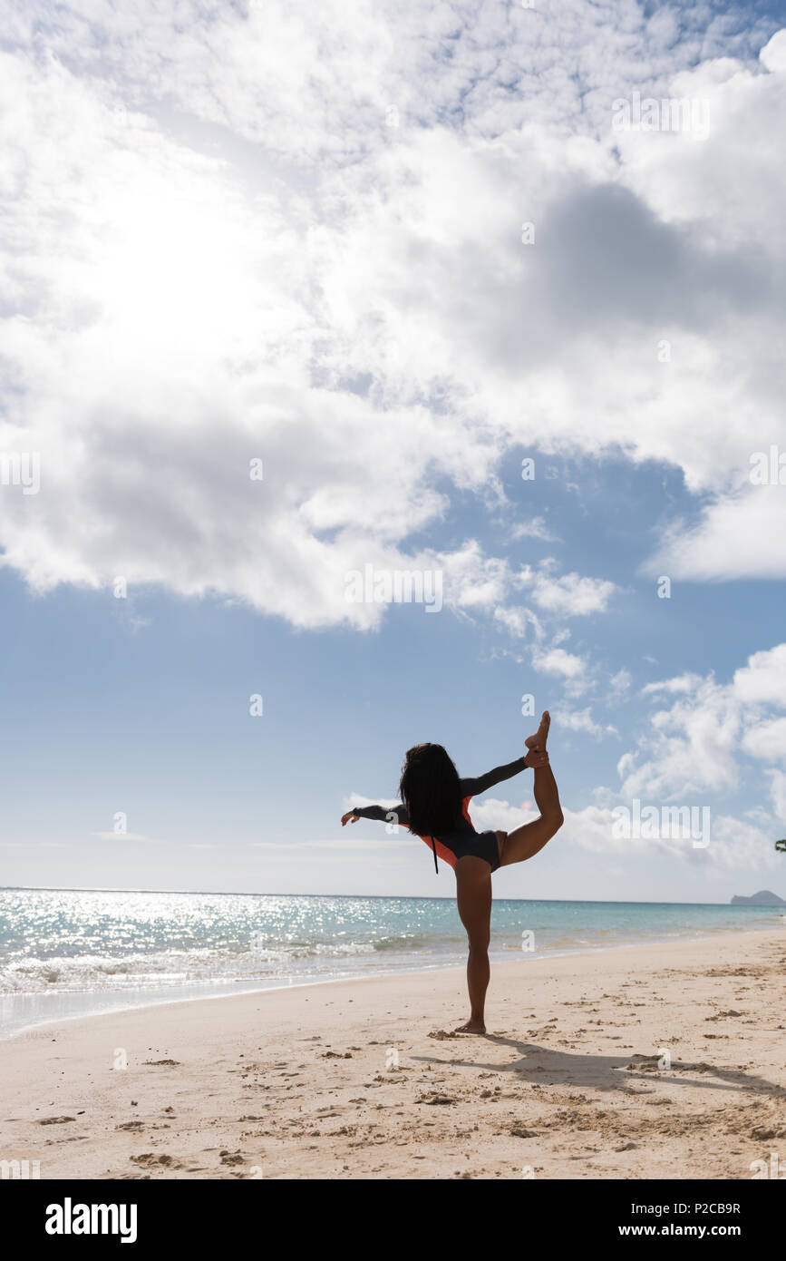 Woman exercising in the beach Stock Photo