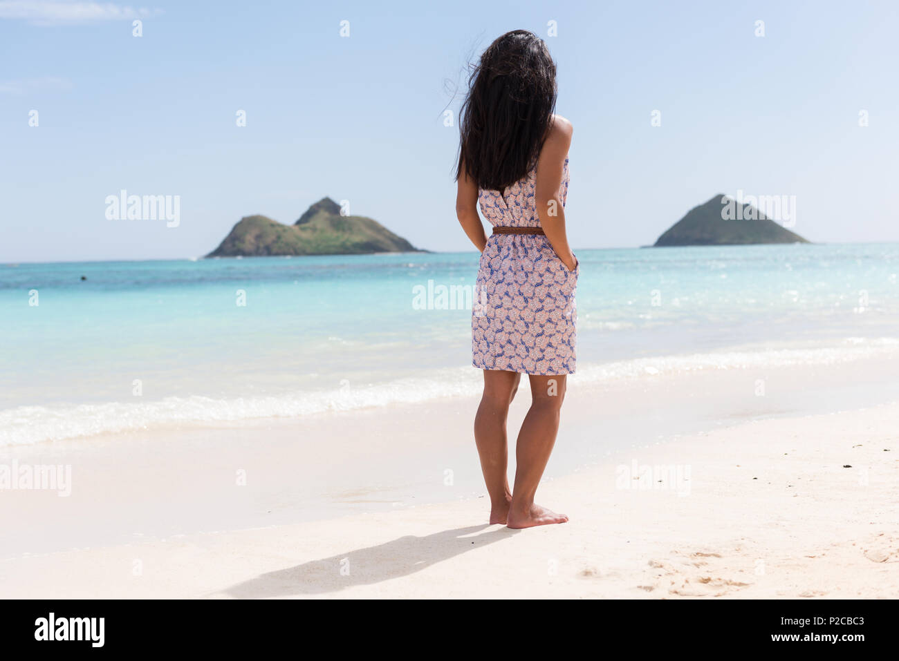 Woman standing with hands in pocket in the beach Stock Photo - Alamy