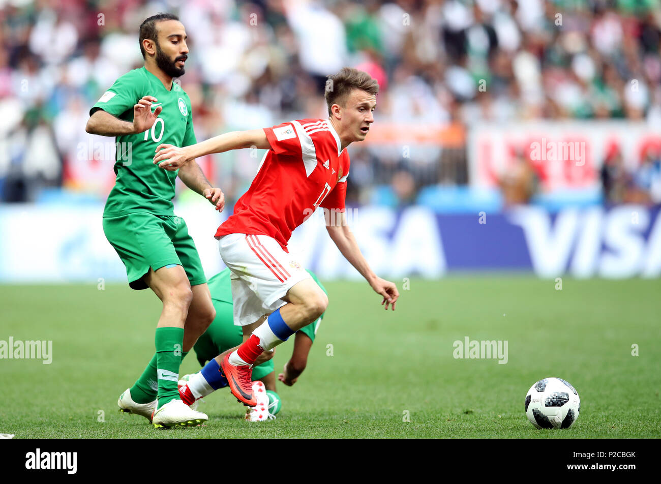 Saudi Arabia's Mohammad Al-Sahlawi (left) and Russia's Aleksandr Golovin battle for the ball during the FIFA World Cup 2018, Group A match at the Luzhniki Stadium, Moscow. Stock Photo