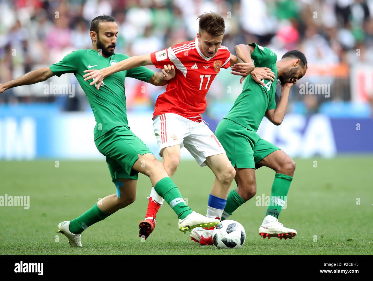 Saudi Arabia's Mohammad Al-Sahlawi (left) and Abdullah Otayf (right) battle for the ball with Russia's Aleksandr Golovin during the FIFA World Cup 2018, Group A match at the Luzhniki Stadium, Moscow. Stock Photo