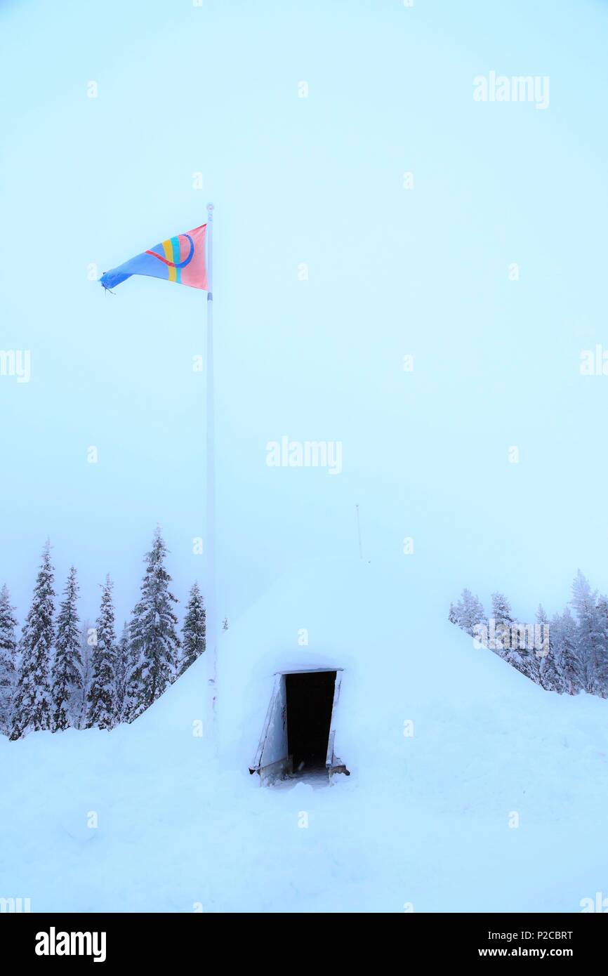 Sweden, Lapland, region listed as World Heritage by UNESCO, Norrbotten County, Arctic Circle Resort with hut and Sami flag on the 66th north latitude Stock Photo