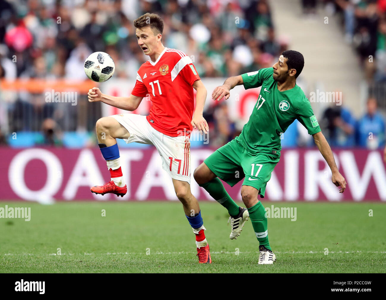 Russia's Aleksandr Golovin (left) and Saudi Arabia's Taisir Al-Jassim battle for the ball during the FIFA World Cup 2018, Group A match at the Luzhniki Stadium, Moscow. Stock Photo