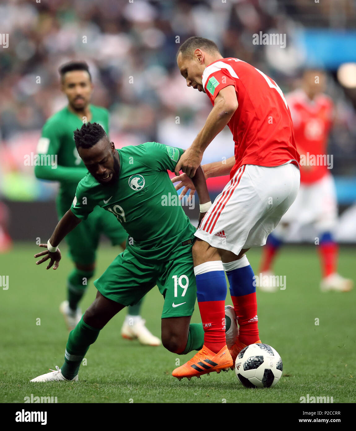 Saudi Arabia's Fahad Al-Muwallad (left) and Russia's Sergei Ignashevich battle for the ball during the FIFA World Cup 2018, Group A match at the Luzhniki Stadium, Moscow. Stock Photo