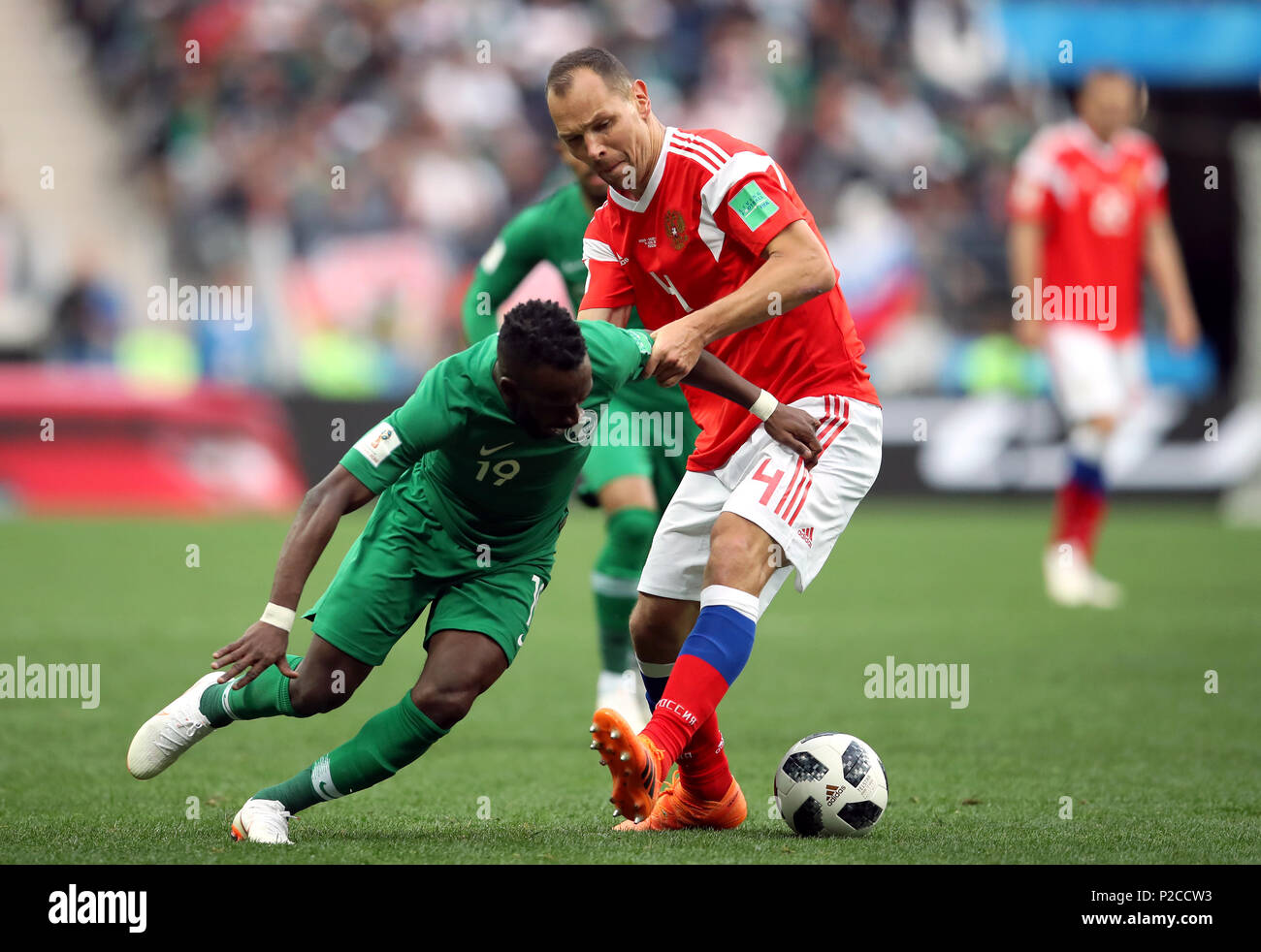 Saudi Arabia's Fahad Al-Muwallad (left) and Russia's Sergei Ignashevich battle for the ball during the FIFA World Cup 2018, Group A match at the Luzhniki Stadium, Moscow. Stock Photo