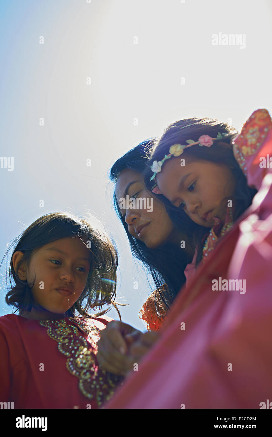 Malay Mother And Her Two Young Daughters Wearing Traditional Baju Kurung Dresses Smiling Happily Into Camera During Hari Raya Celebration Stock Photo Alamy