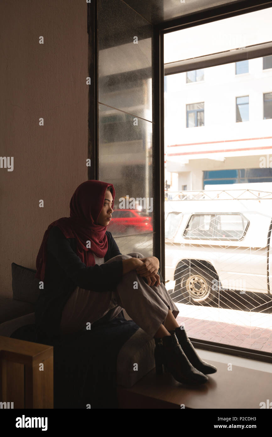 Businesswoman in hijab relaxing at cafeteria Stock Photo