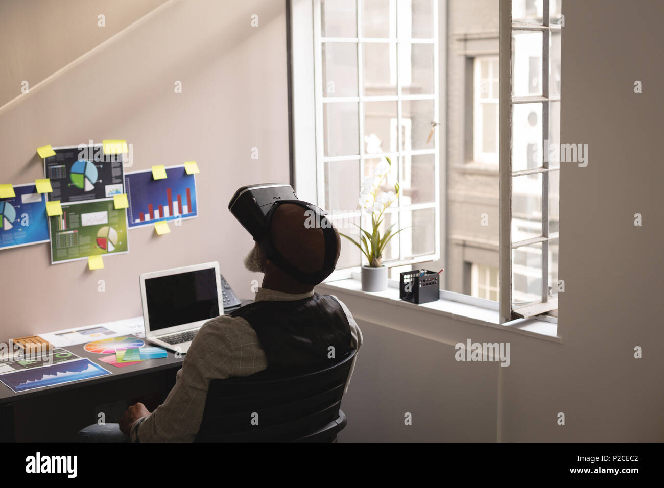 Senior graphic designer using virtual reality headset Stock Photo