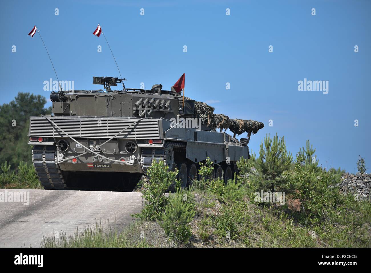 An Austrian Leopard 2A4 tank, operated by Austrian soldiers assigned to 6th Tank Company, 14th Panzer Battalion, fires at its target during the Strong Europe Tank Challenge (SETC), at the 7th Army Training Command's Grafenwoehr Training Area, Grafenwoehr, Germany, June 04, 2018, June 4, 2018. U.S. Army Europe and the German Army co-host the third Strong Europe Tank Challenge at Grafenwoehr Training Area, June 3 - 8, 2018. The Strong Europe Tank Challenge is an annual training event designed to give participating nations a dynamic, productive and fun environment in which to foster military part Stock Photo