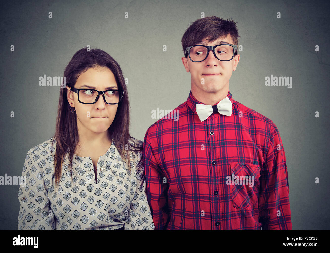 Young man and woman on date feeling awkward being in embarrassed situation Stock Photo