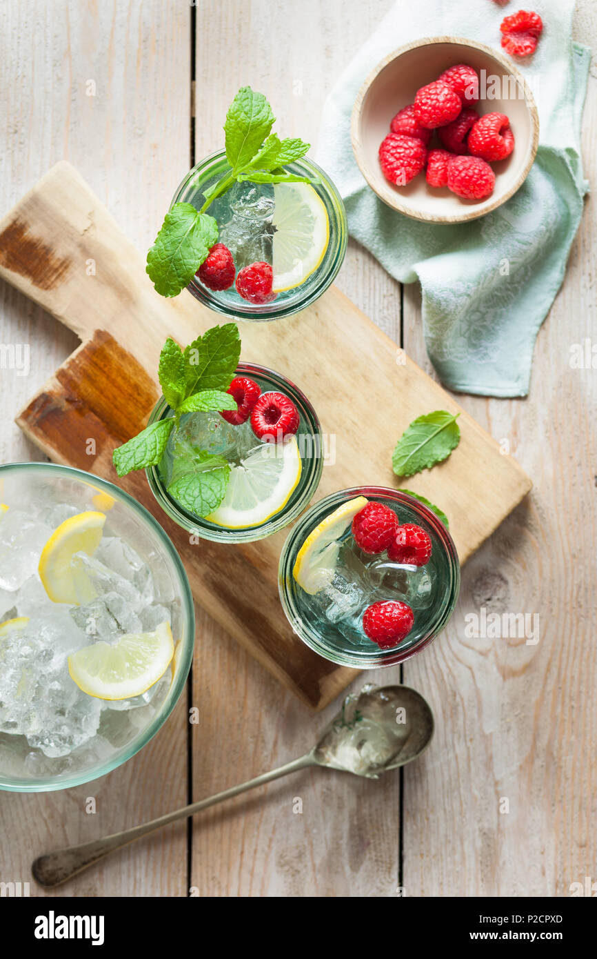 Refreshing Iced Summer Drinks Garnished With Fresh Fruit And Mint Stock