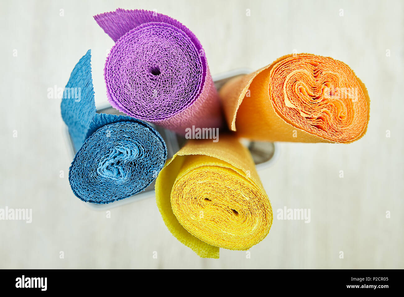 Colorful crepe paper curled into a roll with a spiral pattern when