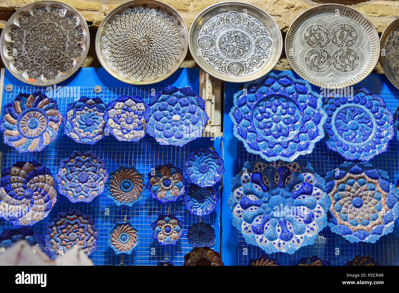 Traditional Iranian plates and dishes with traditional persian ornament in bazaar of Isfahan. Iran Stock Photo