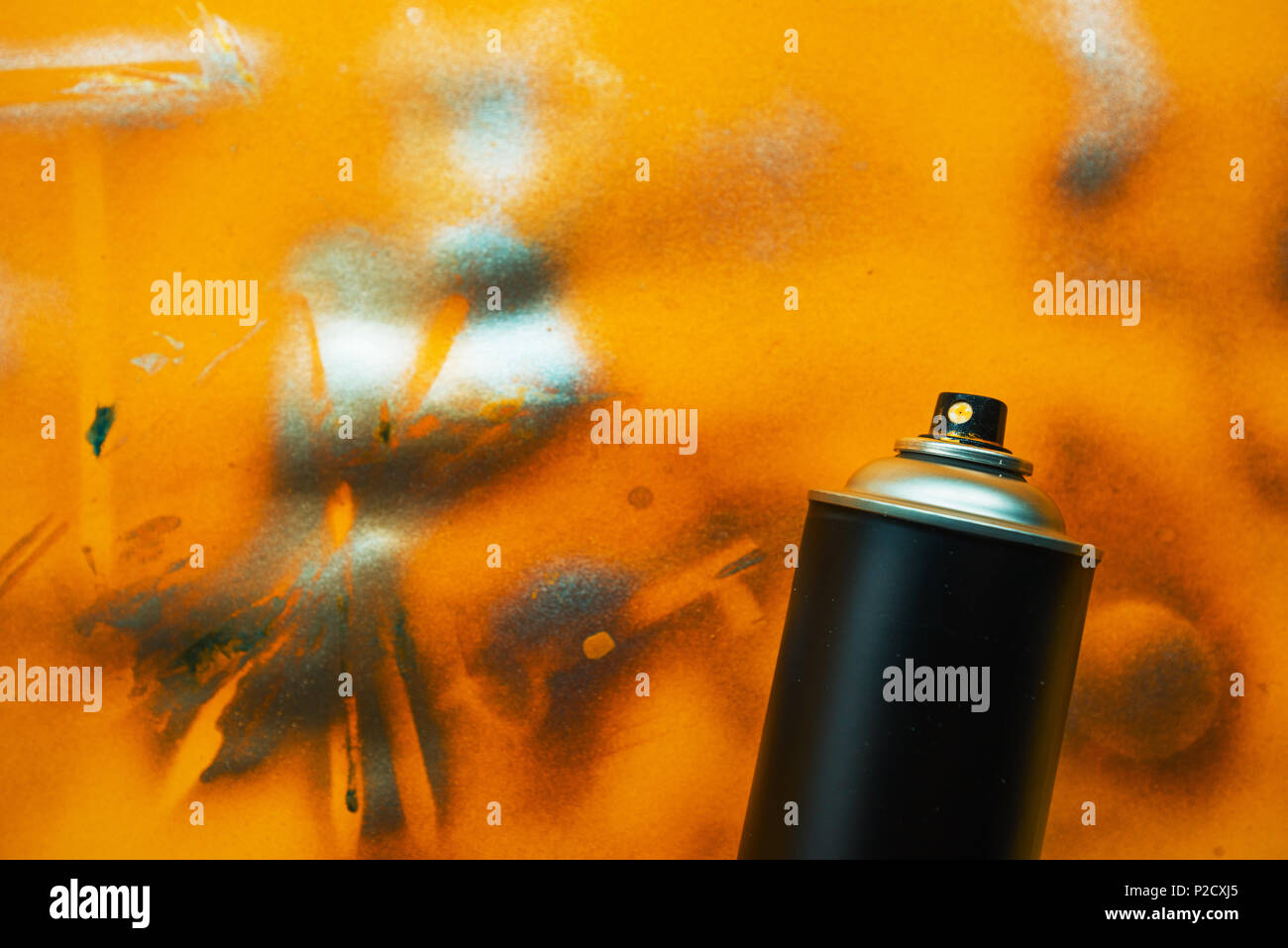 Black color spray can for graffiti artwork on grunge yellow background Stock Photo