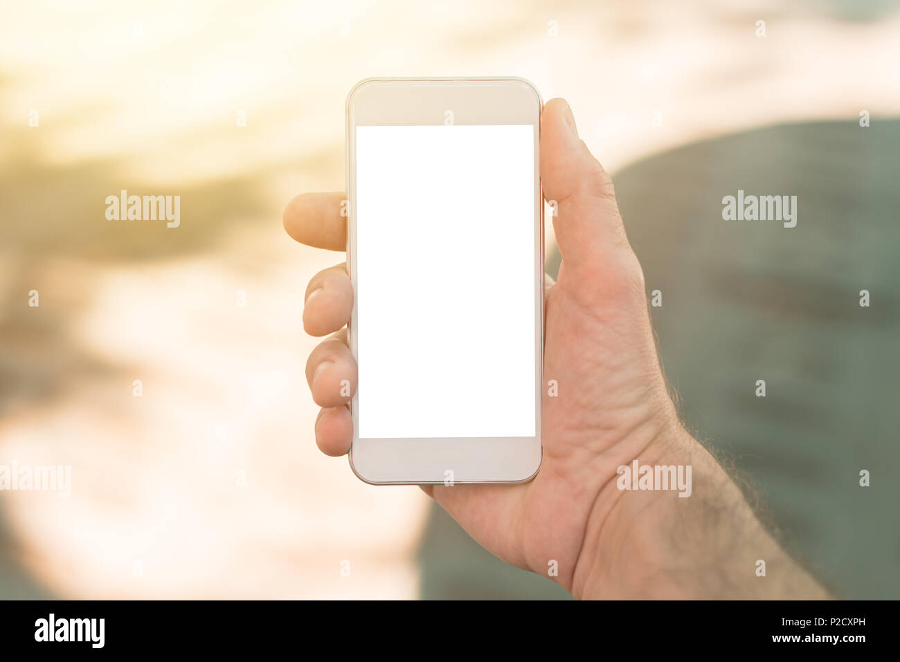 Smart phone with blank screen in male hand. Mock up copy space for mobile app screenshot. Stock Photo