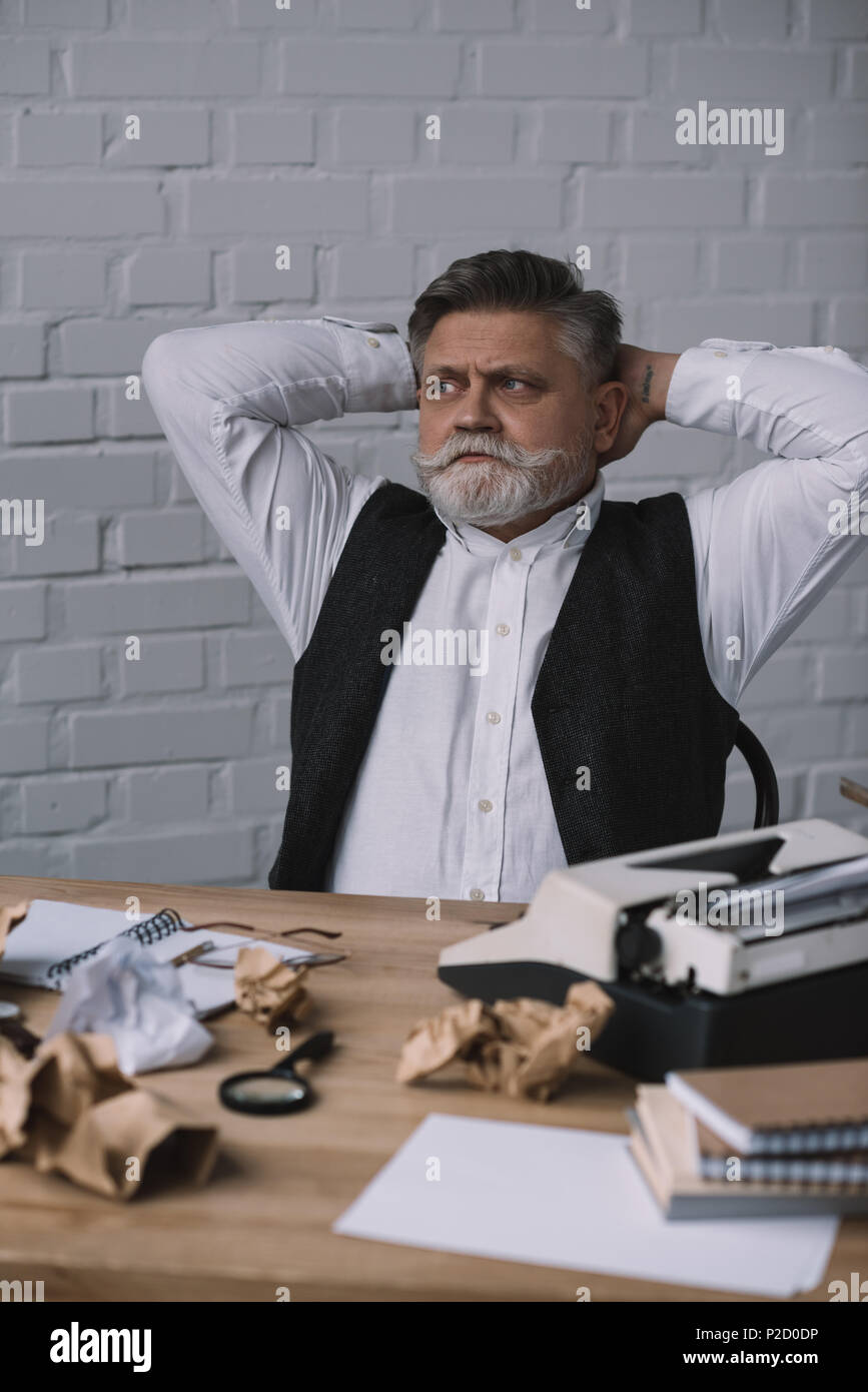 handsome senior writer relaxing at messy workplace Stock Photo - Alamy