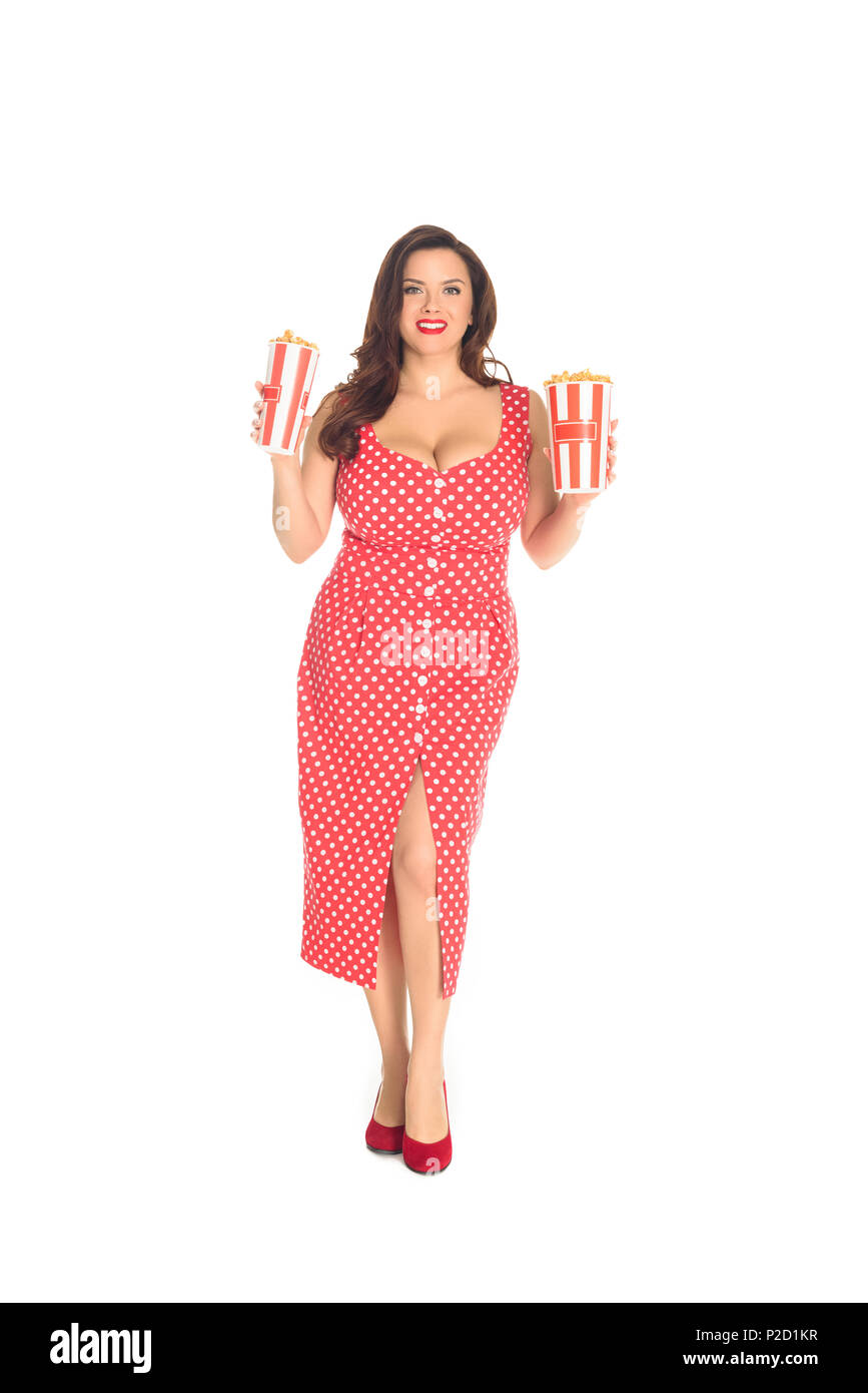 smiling plus size woman in red dress with boxes of popcorn isolated on