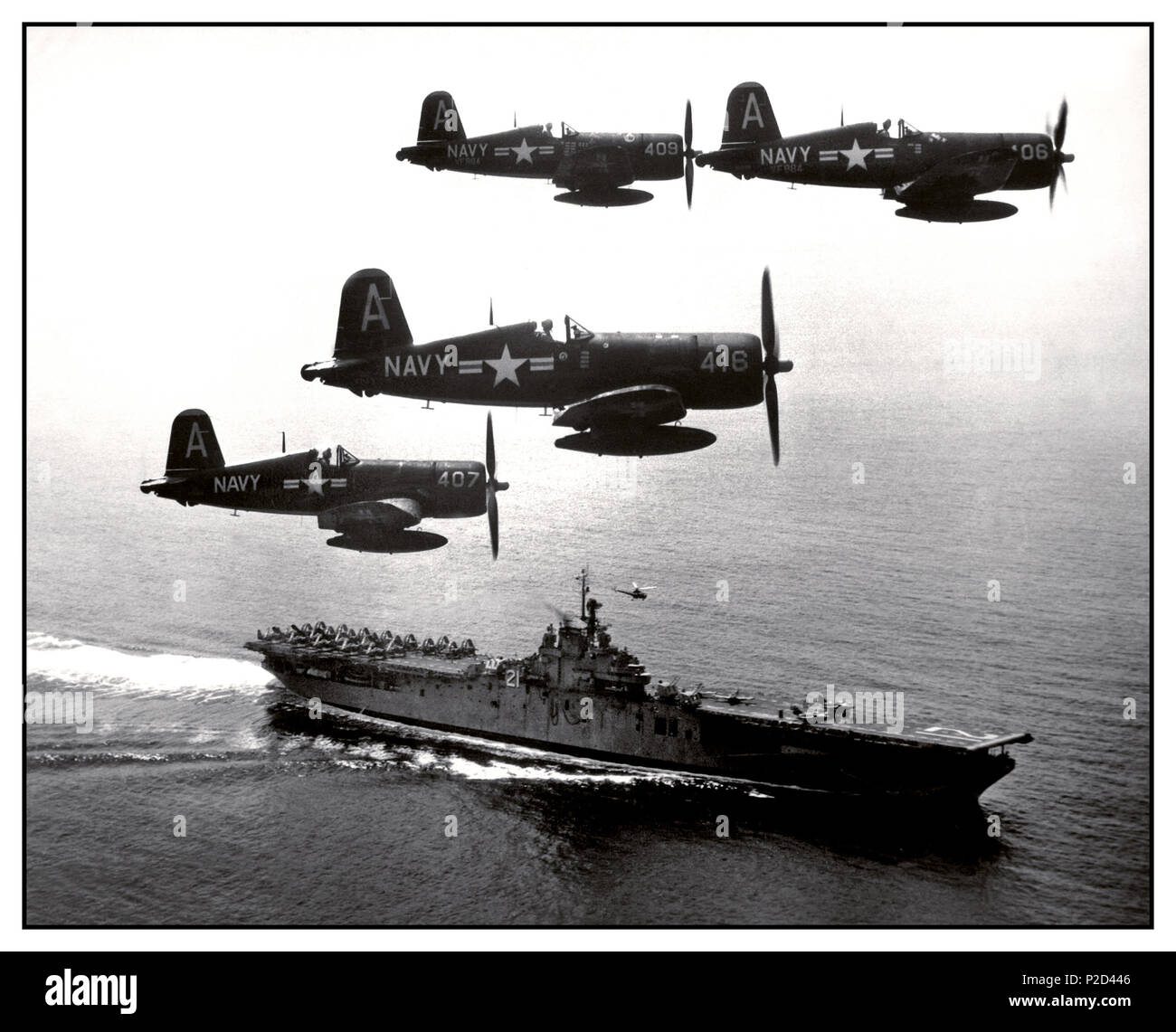 1951 War North Korea F4U's (Corsairs) returning from a combat mission over North Korea circle the USS Boxer as they wait for planes in the next strike to be launched from her flight deck - a helicopter hovers above the ship.  September 4, 1951. Stock Photo