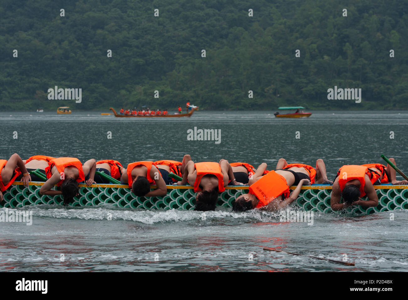 Dragon Boat Festival, rowing team competitors wet their heads in the