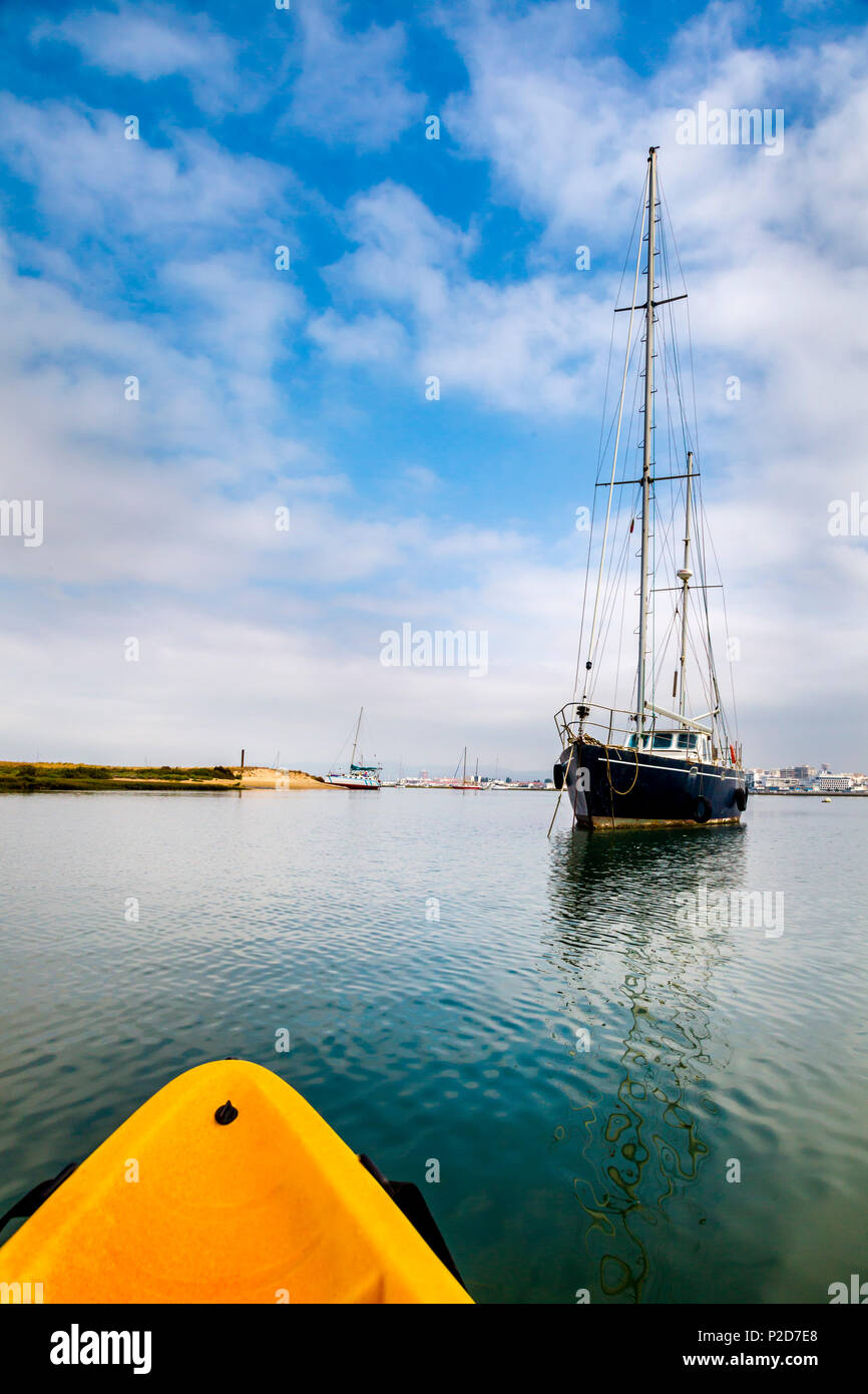 Kayak tour and sailing boat in the lagoon, Parque Natural da Ria Formosa, Faro, Algarve, Portugal Stock Photo