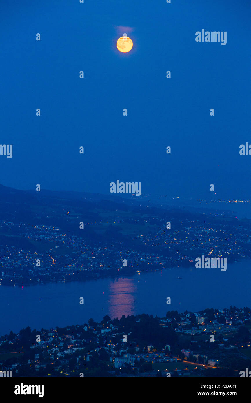 Full moon over lake Zurich and Zurich at night, Zurich, Switzerland Stock Photo
