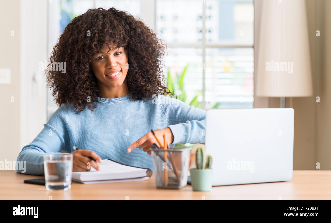 African american woman studying at home using a computer laptop very ...