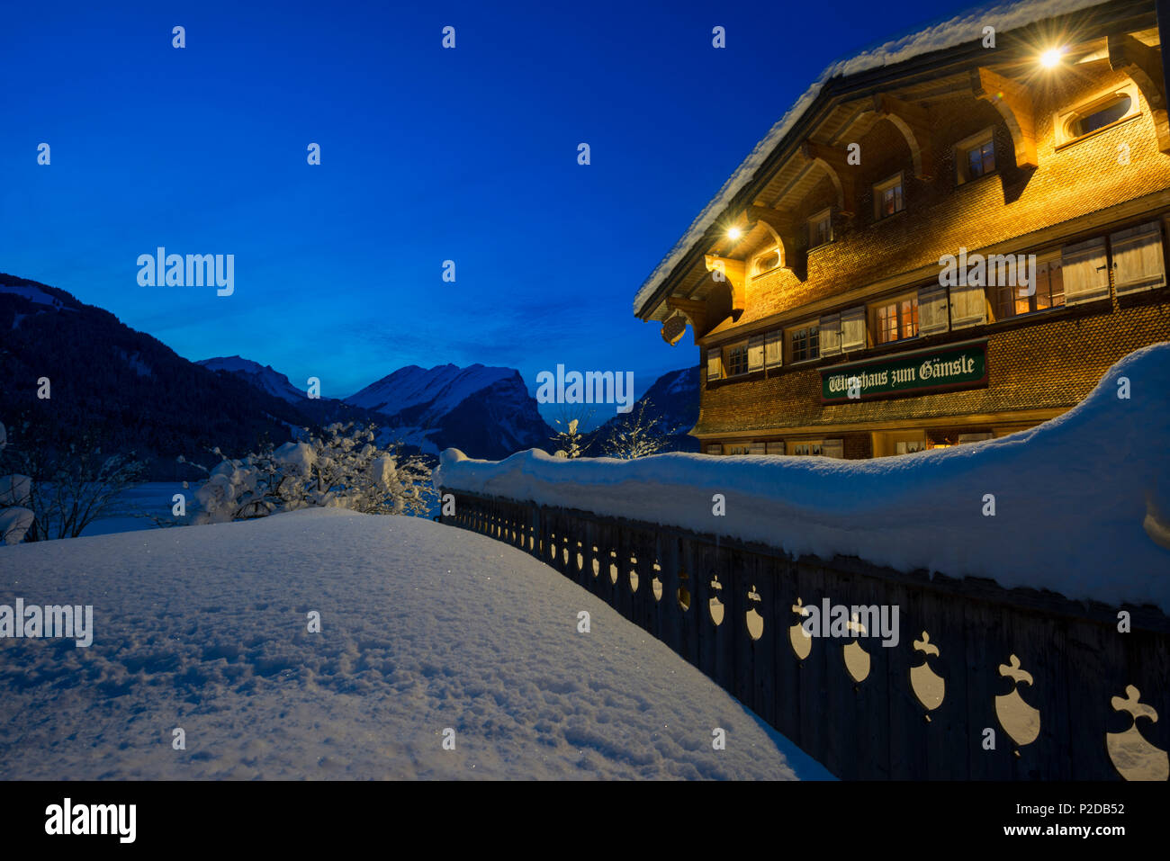 snow covered tavern at night, Schoppernau, Bregenz district, Vorarlberg, Austria Stock Photo
